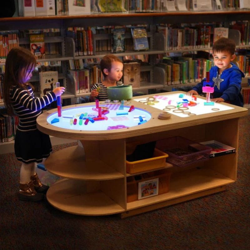 3 Children playing on the Spectrum Light Lab Table with both light panels on 