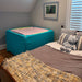 Boundex Sensory Cuddle Box in corner of room next to a bed