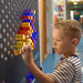 Closeup of young kid putting a LitePin into the LiteZilla Light Wall at school