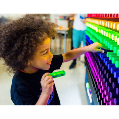 Closeup view of kid with litepin in hand putting it in the LiteZilla Lite Bright Wall