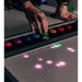 Closeup of hand on buttons of TFH Pixels Pro Interactive Sensory Panel