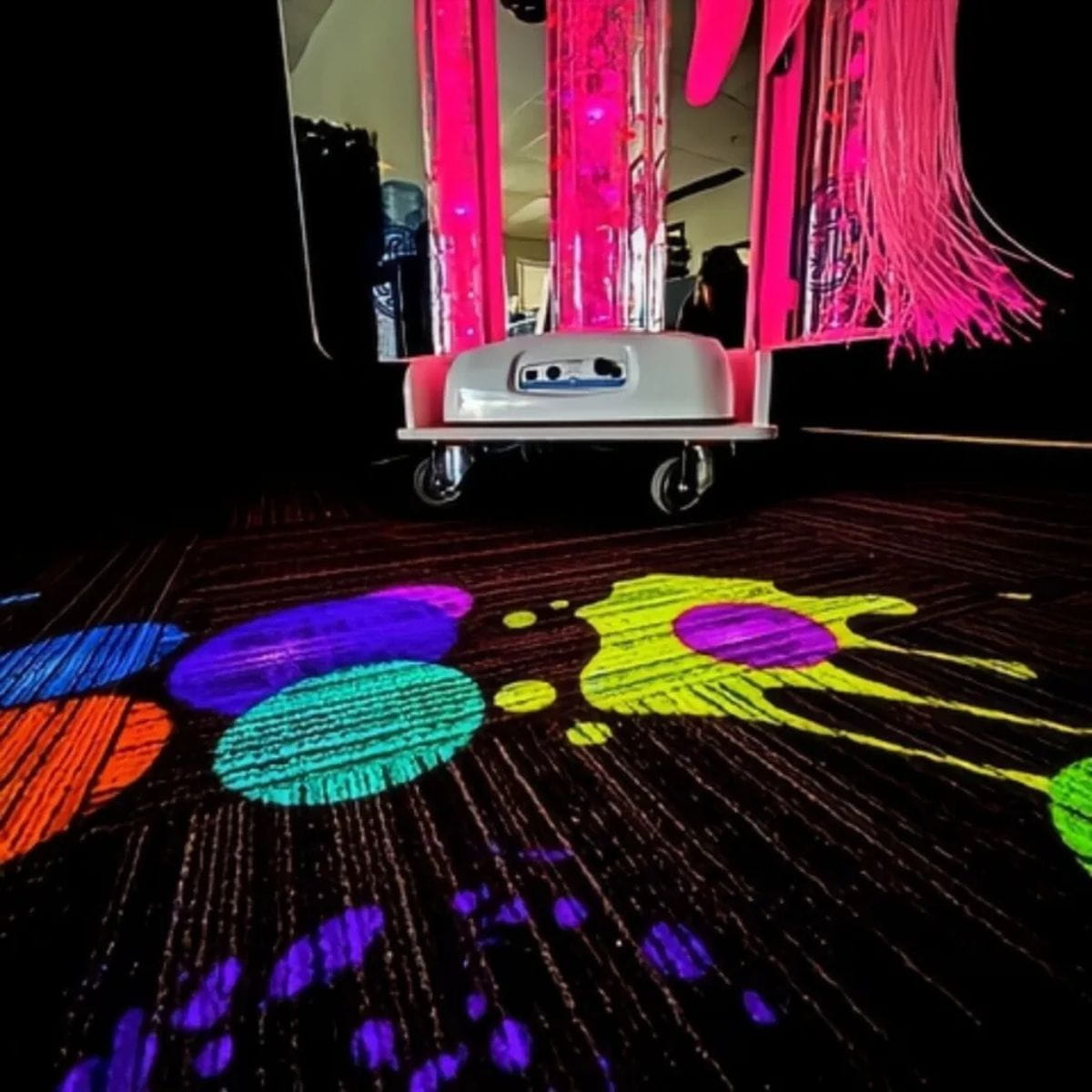Closeup of image on floor from Vecta Budii Mobile Sensory Station with pink bubble tube