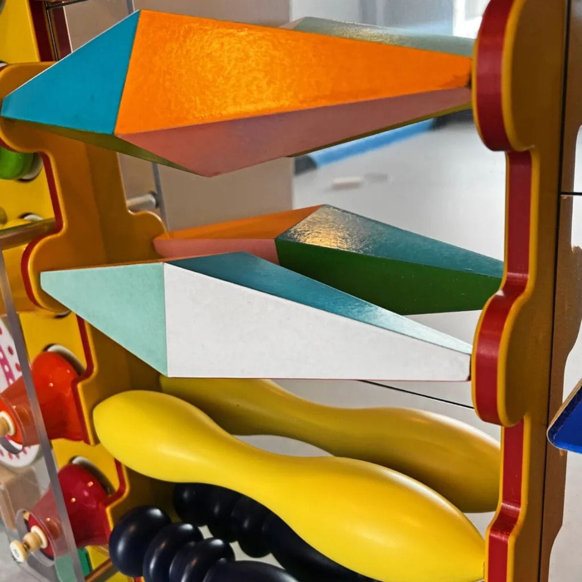 Closeup of rolling shapes on the Kinetic Wonder Sensory Wall
