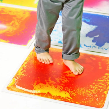 Closeup of two feet on a Large Square Liquid Sensory Floor Tile