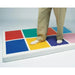 Closeup of two feet on the yellow and purple  squares of the Musical Squares Sensory Equipment
