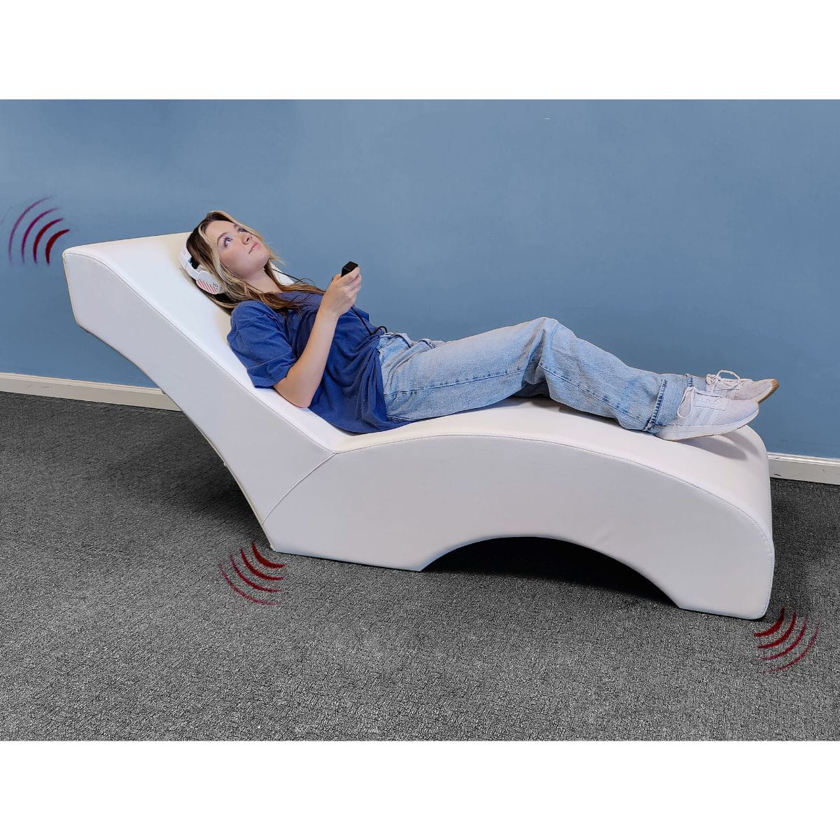 Experia USA Vibro Acoustic Lounger person with headphones laying on it