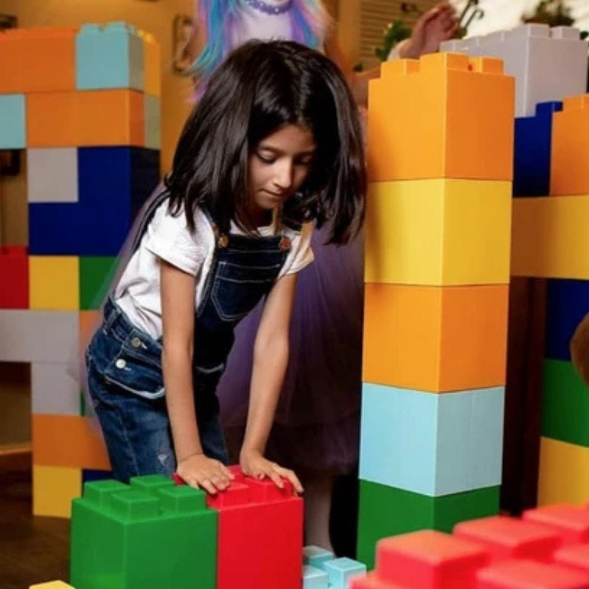 Girl building her masterpiece with the EverBlock Classroom Blocks
