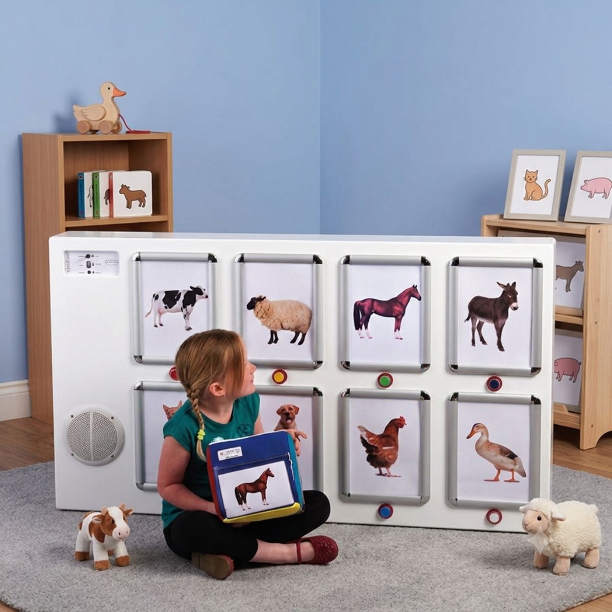 Girl has the Qube in her hand with the IRiS SOundboard behind her in a room
