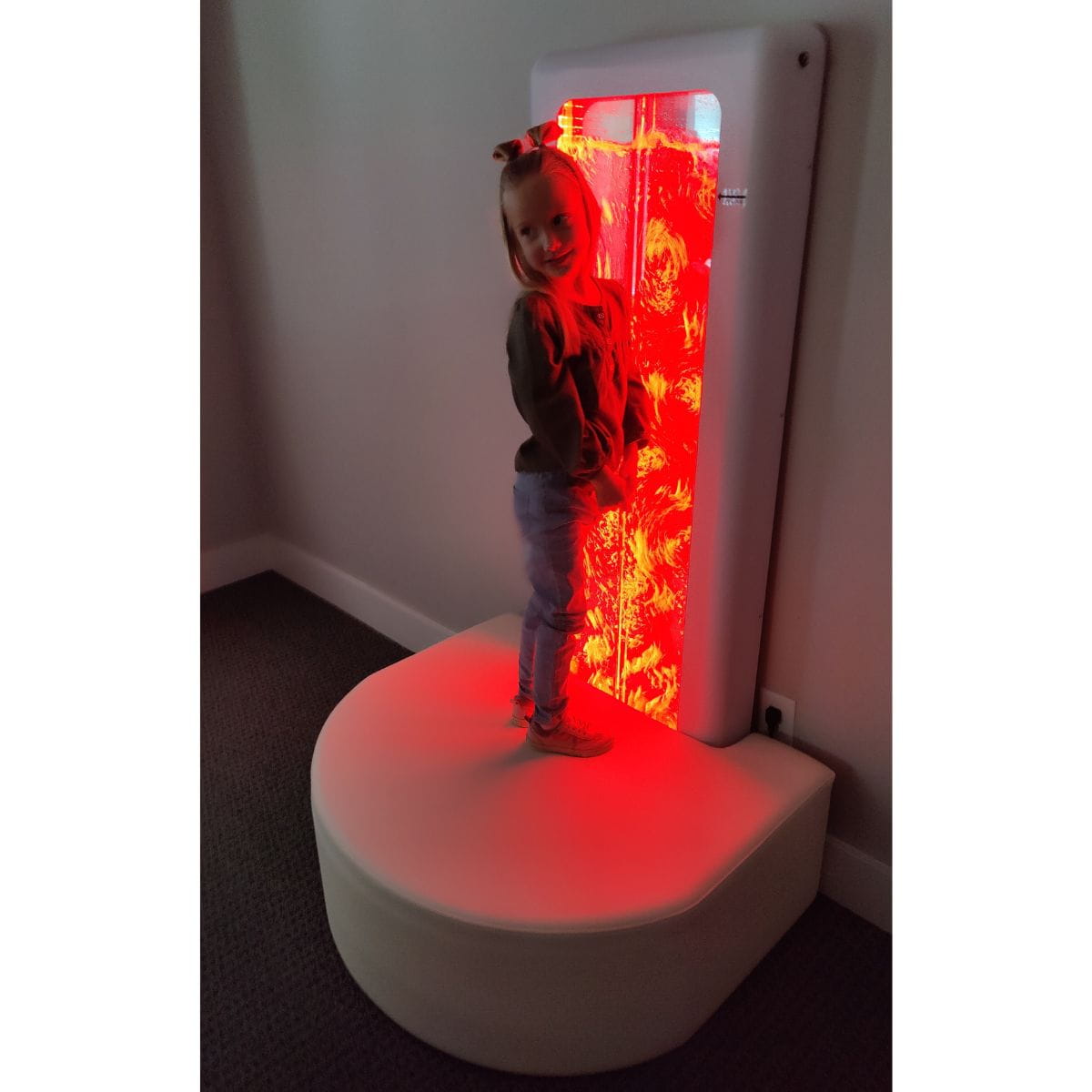 Girl on platform with the Superactive Sensory LED Bubble Wall in red