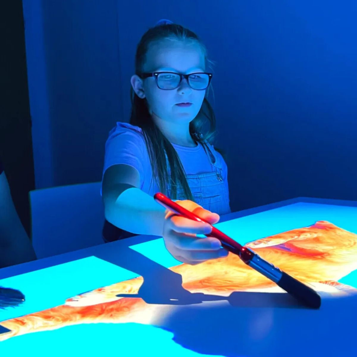 Girl painting an image from Budii Interactive Projector