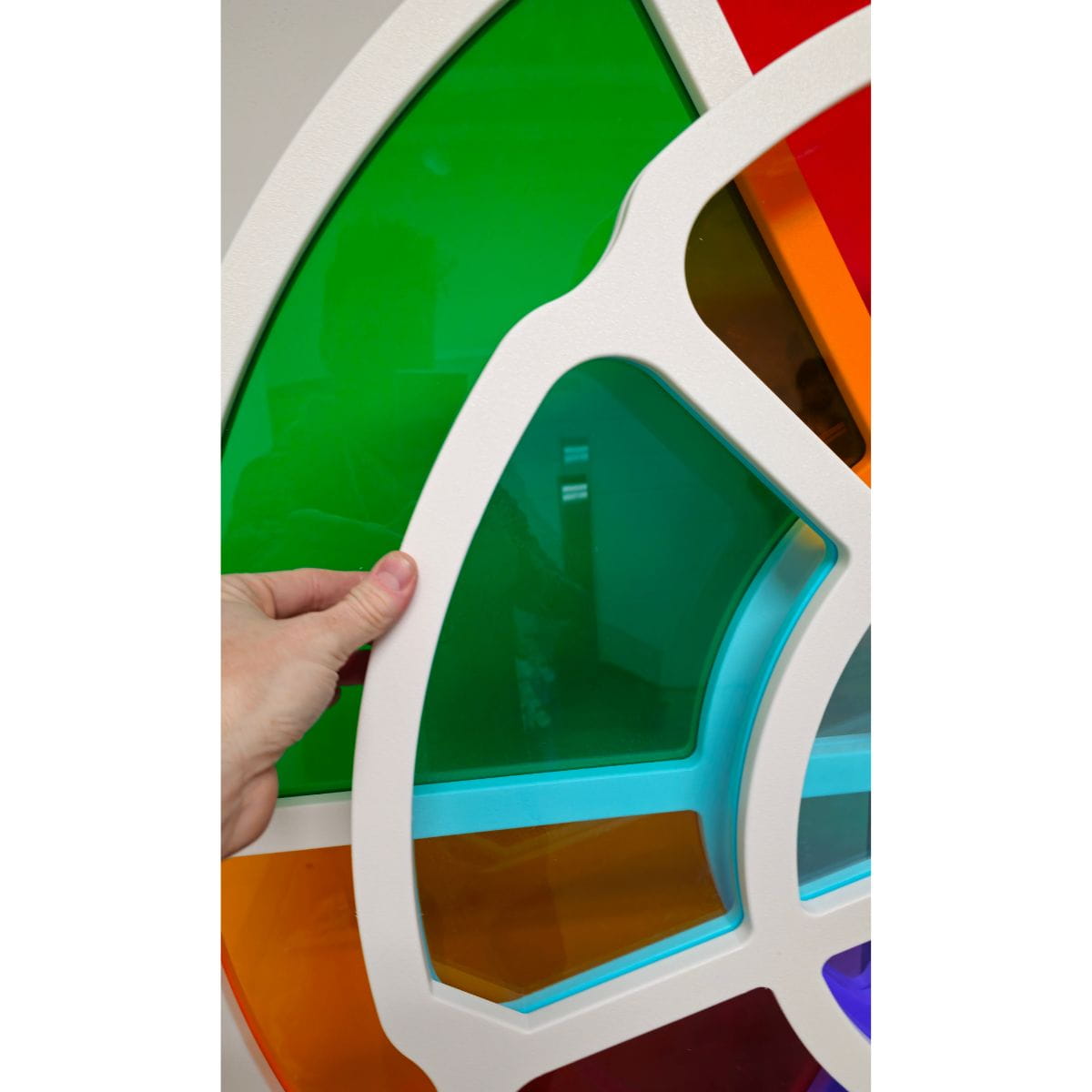 Hand on the smaller wheel of the LiteZilla ChromaWheel ready to spin it