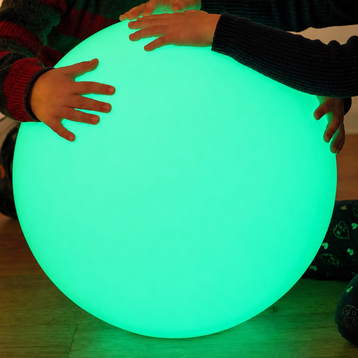 Hands on the Green LED Sensory Ball