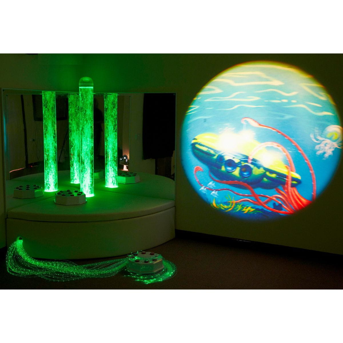 Image of submarine under the sea on wall from Aurora LED projector with bubble tube and Fiber optics lit up in green color that all comes with Experia Sensory Corner bundle 