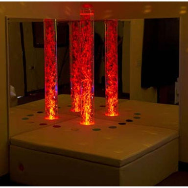 Interactive Bubble Tube Corner Set glowing in red with the lights out and reflection in mirrors