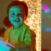 Interactive LED Bubble Tube behind smiling kid