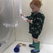 Kid inside the Portable Sensory Den Kit with 100 fiber optic strands in his hand