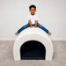 Kid on top of the Kid smiling while laying in the Tranquility Fiber Optic Sensory Tunnel