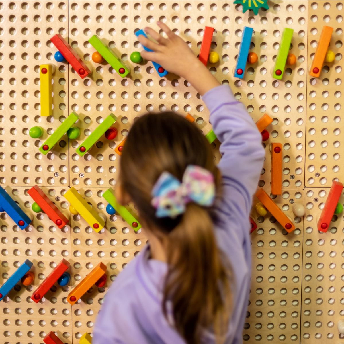 Kid playing on the LiteZilla Kidworx Interactive Game Board