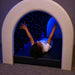 Kid smiling while laying in the Tranquility Fiber Optic Sensory Tunnel looking up at the lights