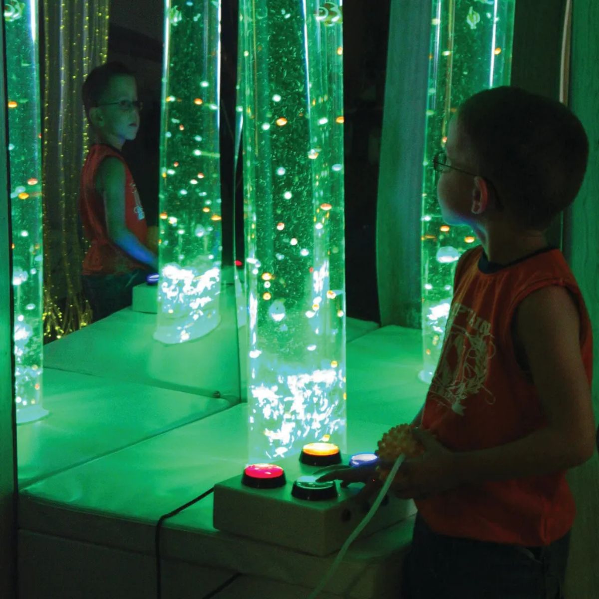 Kid changing the color to green on the Interactive Bubble Tube with controller