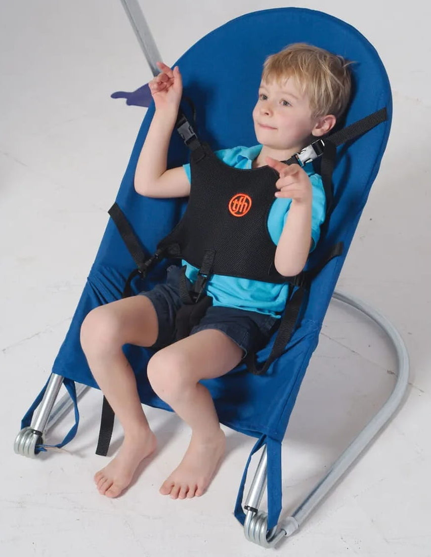 Kid harnessed in the Sensory Bouncy Chair