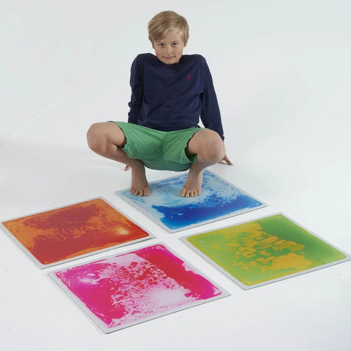 Kid has two feet on one Large Square Liquid Sensory Floor Tiles