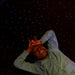 Kid laying on the LED Fiber Optic Star Carpet with a calming look