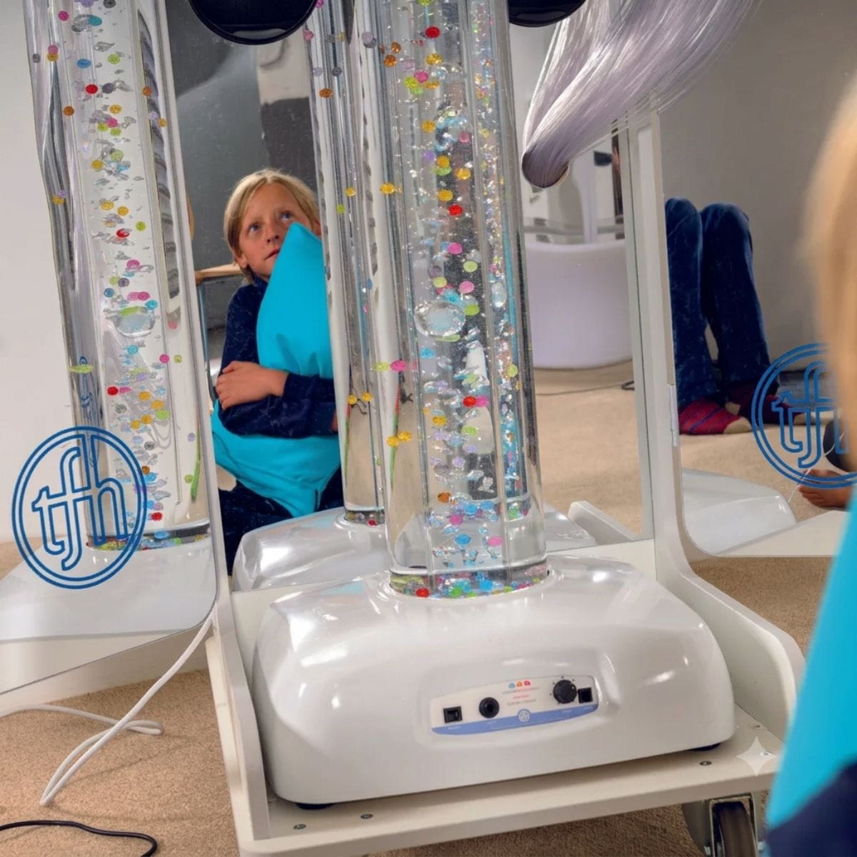 Kid looking up at the Vecta Delight Mobile Sensory Station bubble tube in action