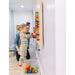 Kid playing with LiteZilla Mini on wall making a design with mom next to them
