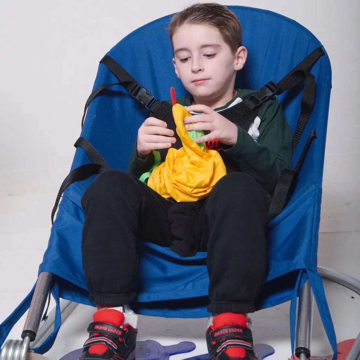Kid playing with a toy while in the TFH Bounce Chair