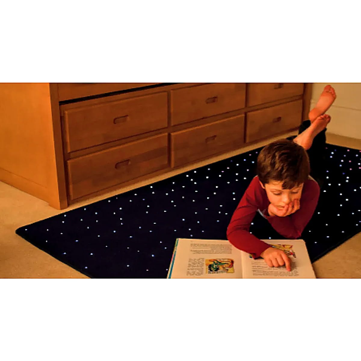 Kid reading a book on Fiber Optic Starfield Carpet