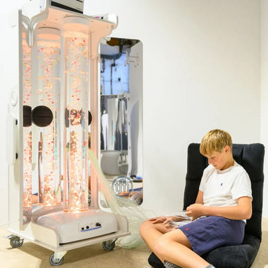Kid sitting next to the Vecta Delight Mobile Sensory Station playing with the fiber optic tails