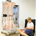 Kid sitting next to the Vecta Delight Mobile Sensory Station playing with the fiber optic tails