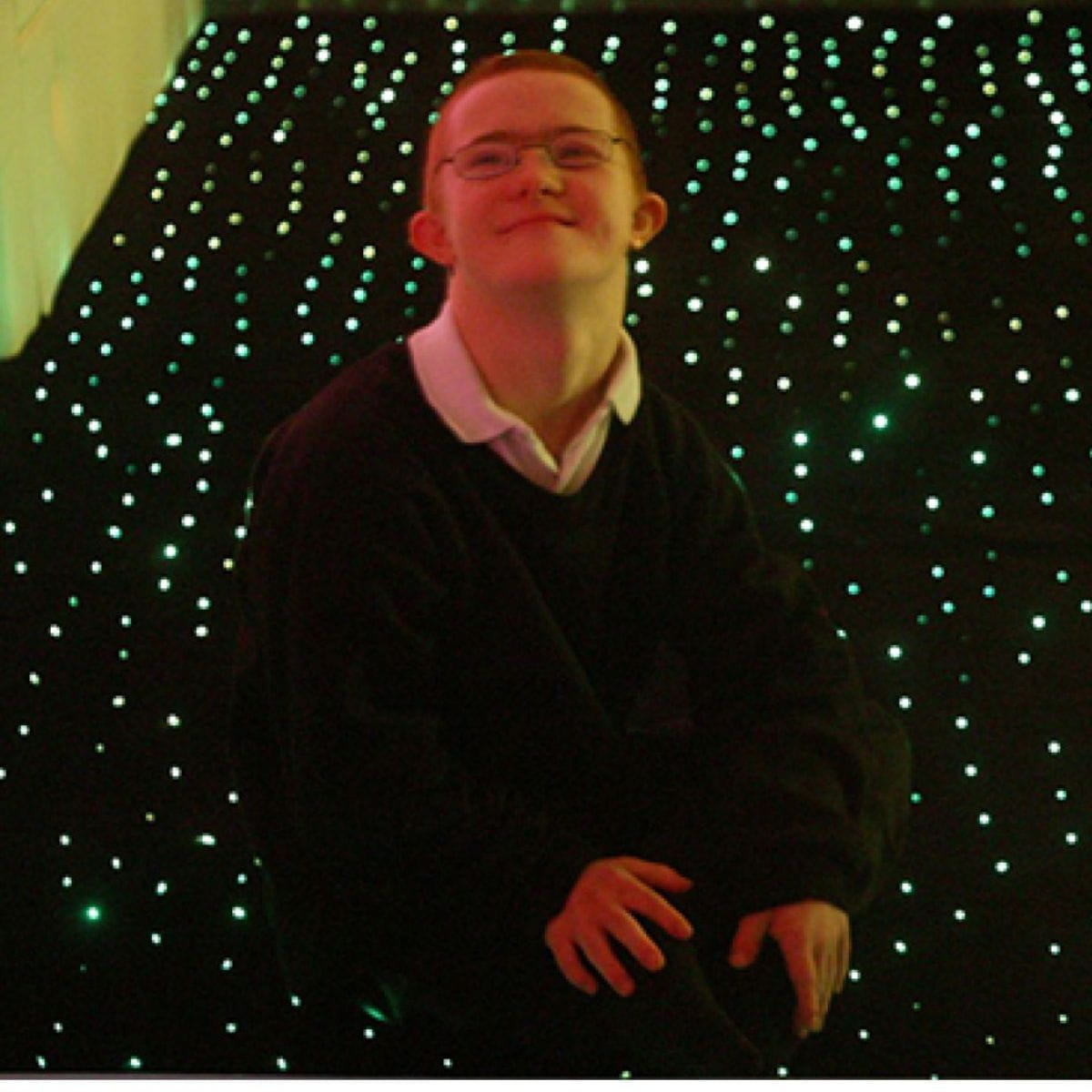 Kid sitting on LED Fiber Optic Star Carpet and looking up happy