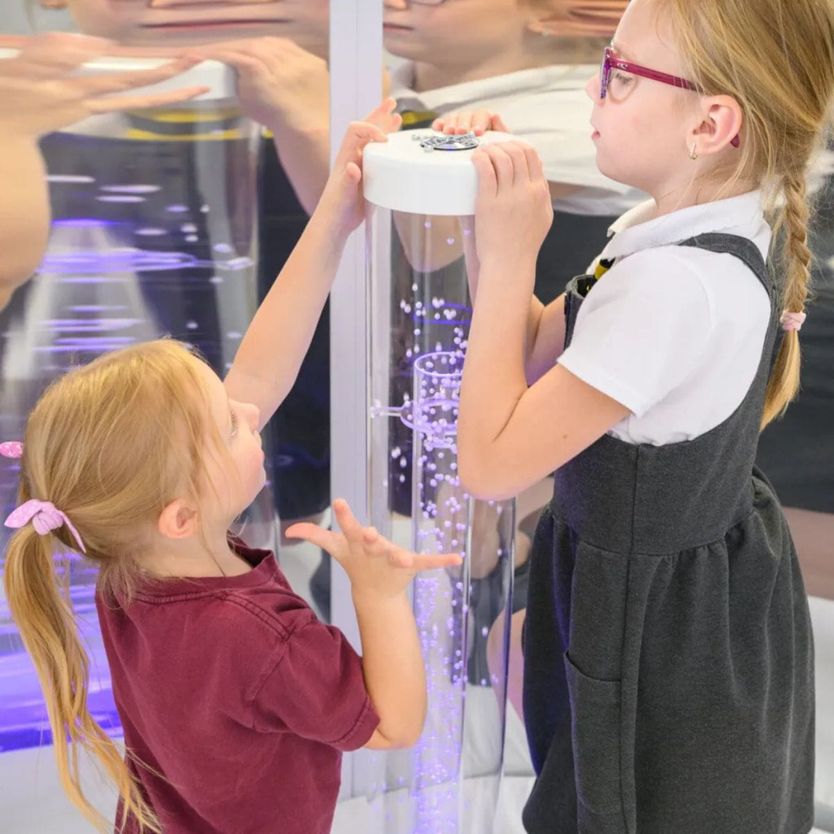 Kids looking at the top of the Interactive Hurricane Tube