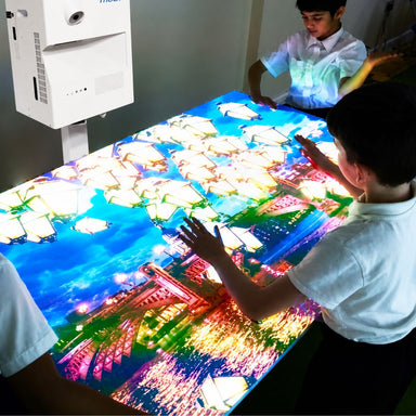 Kids playing with image from omiVista Mobii Interactive Projector