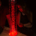 Kid staring at the Interactive Hurricane Tube in red 