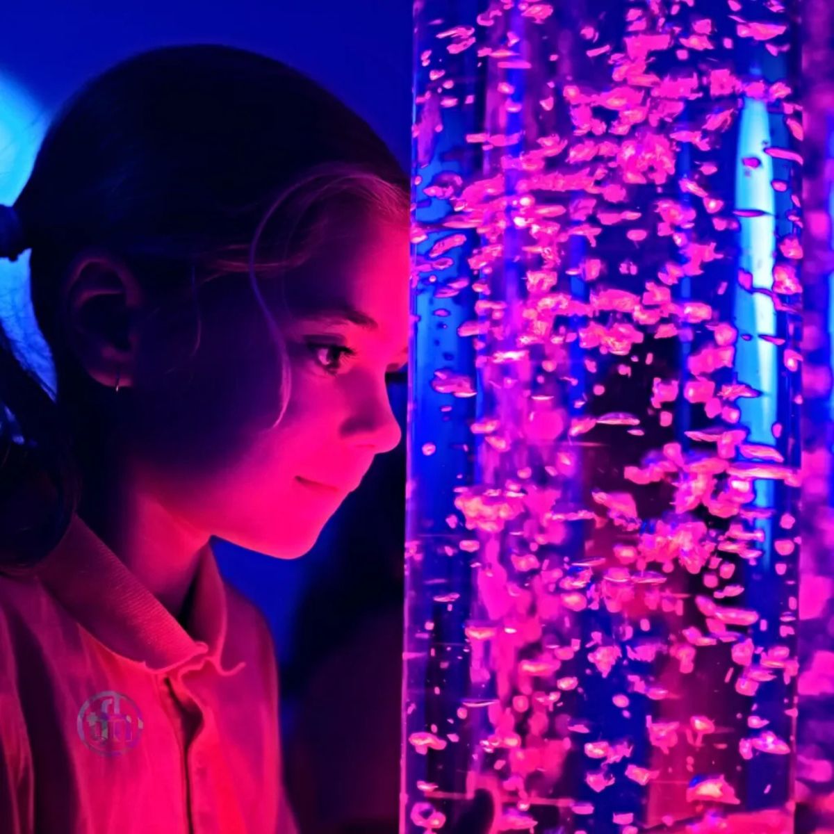 Kid staring at the bubbles coming from TFH Interactive Bubble Tube