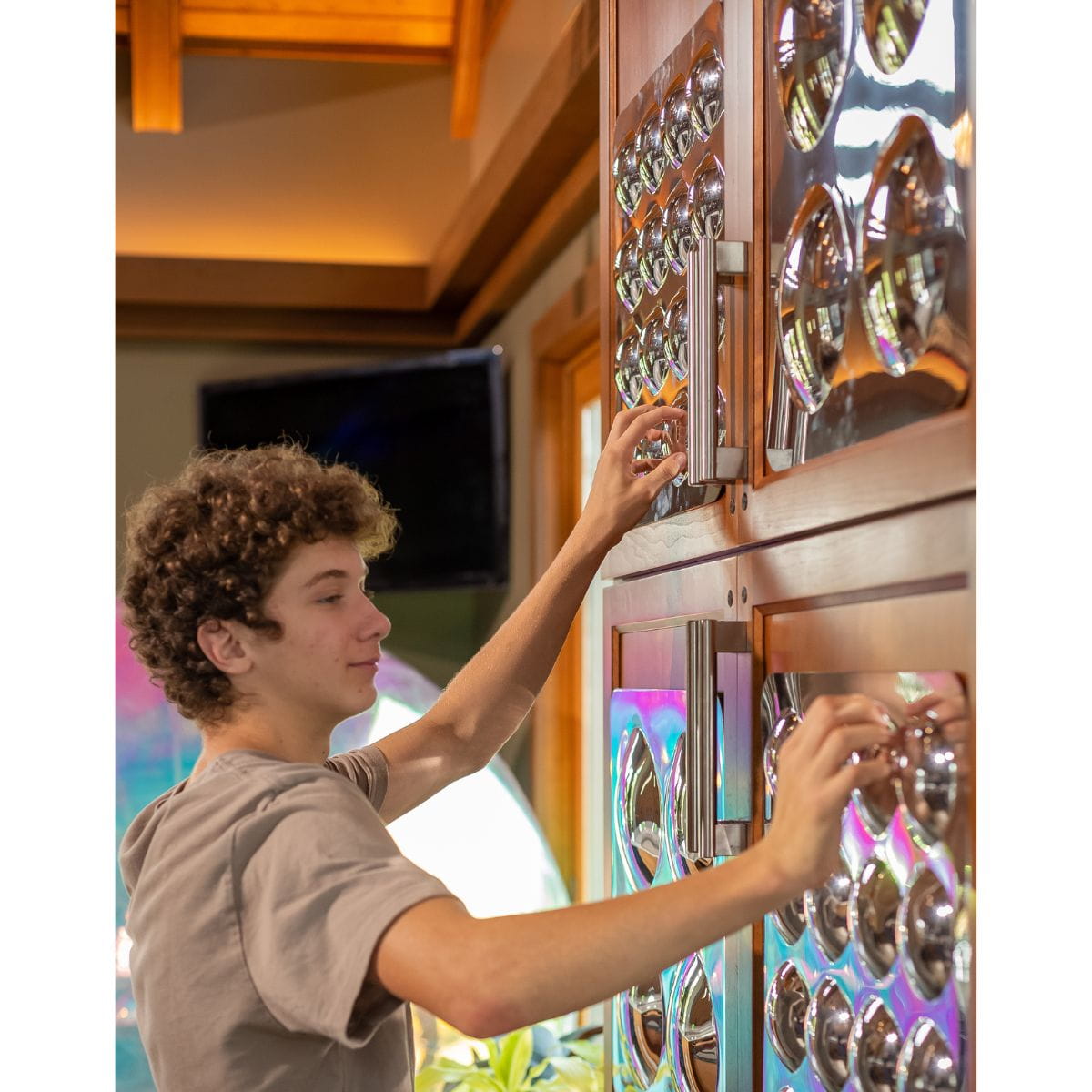 Kid touching Bubble Mirror Panels with both hands