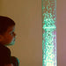 Kid watching the green tabletop waterless bubble tube
