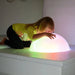 Kid with face and hands on the glowing Sound Light Dome Platform
