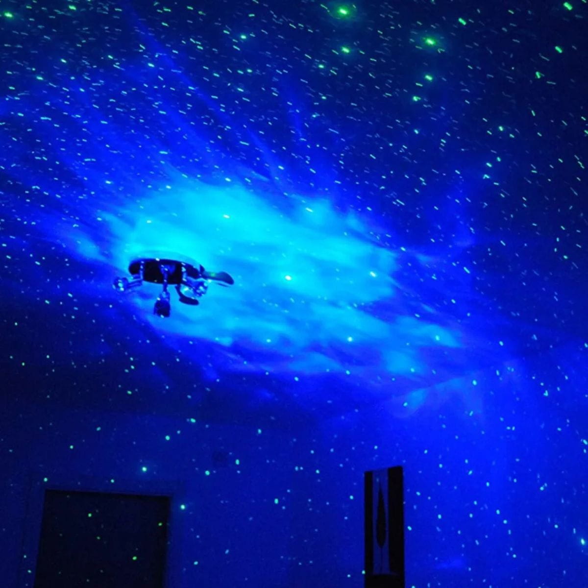 LED Laser Star Projector displays stars and clouds in dark room 