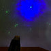 LED Laser Star Projector in dark room with stars and clouds on wall