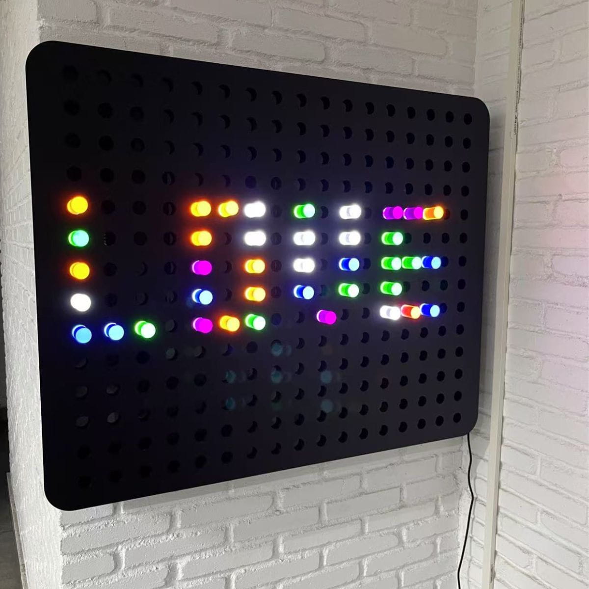 'LOVE' spelled out with colorful lights on PixelPop Sensory Light Wall Panel