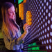 Lady putting the litepins into 12x6 LiteZilla Lite Brite Wall