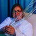 Lady playing with the fiber optic sensory light curtain strands