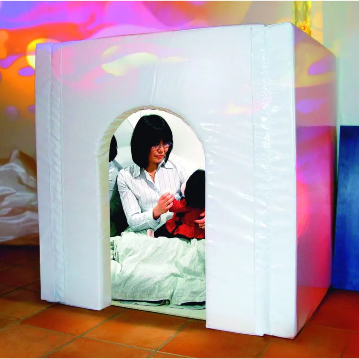 Mother and kid inside the portable sensory den tent having fun