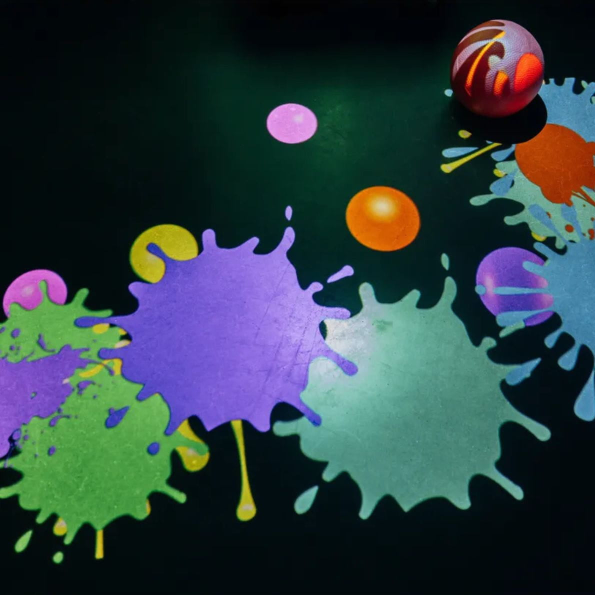 Paint splatter visual on floor from Vecta Budii Mobile Sensory Station