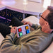 Person with the TFH 4 Button Wireless Color Controller in their hands
