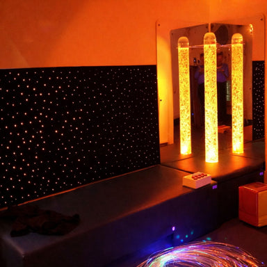 Sensory Room LED Fiber Optic Wall Carpet lit up with bubble tube next to it